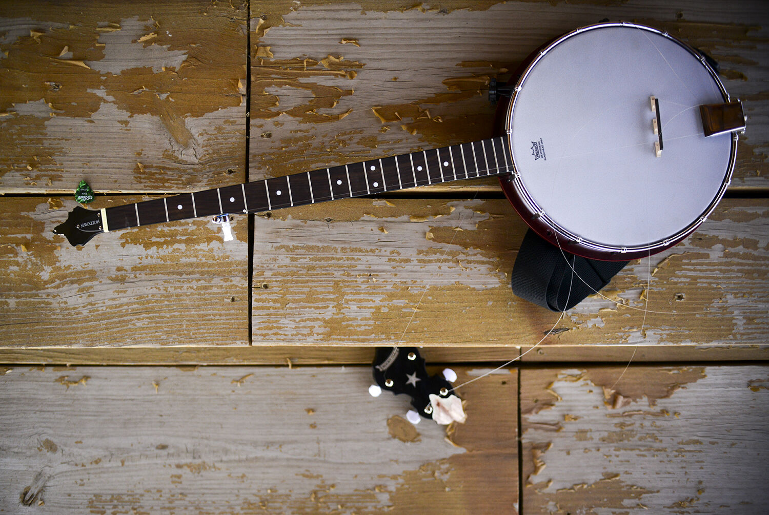 A banjo sits in a few pieces on the steps of the grandstands